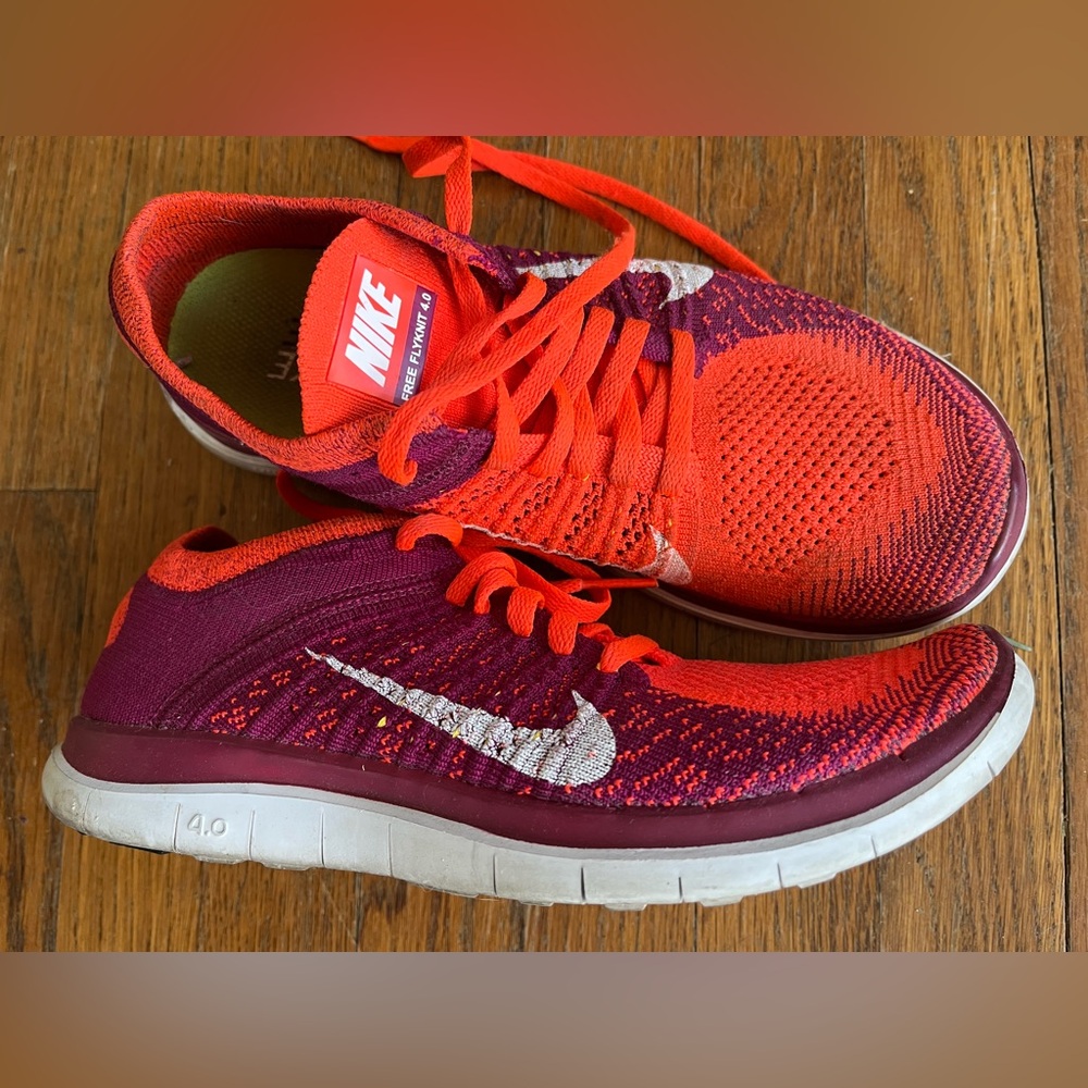 Nike Women’s Flyknit Running Shoes in Orange and Burgundy with White Swoosh